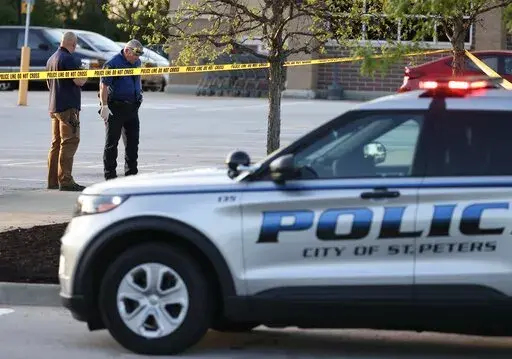Police investigate the scene where an officer was shot in the leg in a parking lot, April 29, 2021, in St Peters, Mo. A federal judge ruled Tuesday, March 7, 2023, that a Missouri law banning local police form enforcing federal gun laws is unconstitutional. (David Carson/St. Louis Post-Dispatch via AP, File)