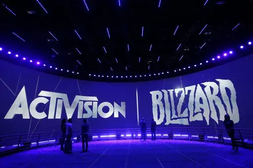 The Activision Blizzard Booth is shown on June 13, 2013 the during the Electronic Entertainment Expo in Los Angeles. Microsoft is buying Activision Blizzard, Tuesday, Jan. 18, 2022,  for $68.7 billion to gain access to blockbuster games including Call of Duty and Candy Crush. The all-cash deal will let Microsoft accelerate mobile gaming and provide it building blocks for the metaverse, or a virtual environment.  (AP Photo/Jae C. Hong, File)