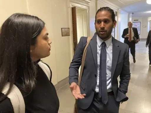 Jay Devineni, right, a student at the University of Missouri School of Medicine, talks with fellow medical school student Supriya Vuda in the hallway of the Missouri Capitol in Jefferson City, Mo., on March 28, 2023. Devineni and Vuda testified against legislation in a Senate committee that would restrict diversity, equity and inclusion initiatives in medical schools and among health care providers. (AP Photo/David A. Lieb)