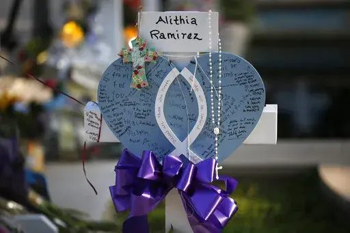 Alithia Ramirez's cross stands at a memorial site for the victims killed in this week's shooting at Robb Elementary School in Uvalde, Texas, Friday, May 27, 2022. (AP Photo/Dario Lopez-Mills)