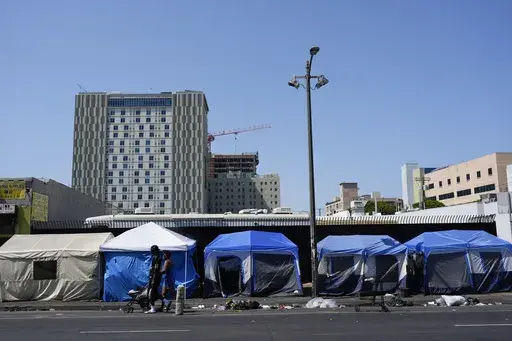Tents are lined up on Skid Row Thursday, July 25, 2024, in Los Angeles. California Gov. Gavin Newsom issued an executive order Thursday to direct state agencies on how to remove homeless encampments, a month after a Supreme Court ruling allowing cities to enforce bans on sleeping outside in public spaces. (AP Photo/Jae C. Hong)