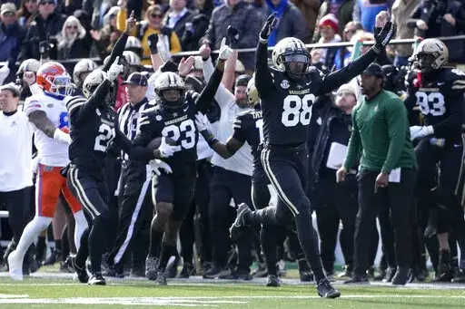 Vanderbilt defensive end Michael Owusu (88) celebrates after Jaylen Mahoney (23) intercepted a pass against Florida in the second half of an NCAA college football game Saturday, Nov. 19, 2022, in Nashville, Tenn. Vanderbilt won 31-24. (AP Photo/Mark Humphrey)