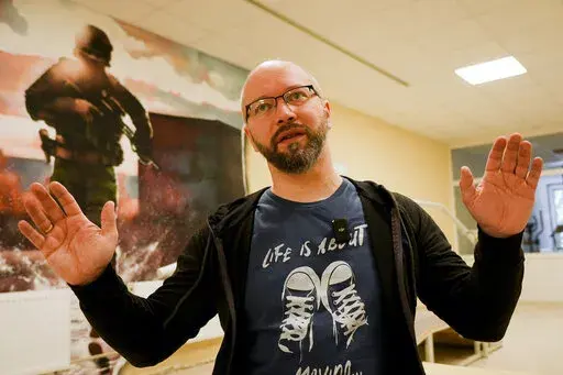 Witalij Miskow, 45, speaks about his mental trauma at a clinic which treats veterans for PTSD, post-combat stress and post-concussion trauma, in Kyiv, Ukraine, Monday, Nov. 21, 2022. When peace returns to Ukraine, many thousands of its combatants will likely return with psychological scars from the battlefields. A mental health rehabilitation center for soldiers on the outskirts of Ukraine's capital, Kyiv, treats post-traumatic disorders with acupuncture, soothing sounds and other therapies. (AP