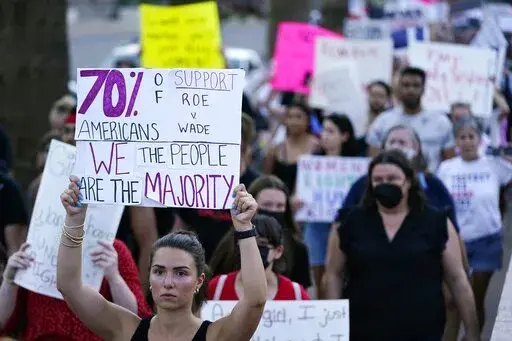 Protesters march around the Arizona Capitol in Phoenix after the Supreme Court decision to overturn Roe v. Wade, Friday, June 24, 2022. A new Arizona law banning abortions after 15 weeks of pregnancy takes effect Saturday, Sept. 24, 2022 as a judge weighs a request to allow a pre-statehood law that outlaws nearly all abortions to be enforced. (AP Photo/Ross D. Franklin, File)
