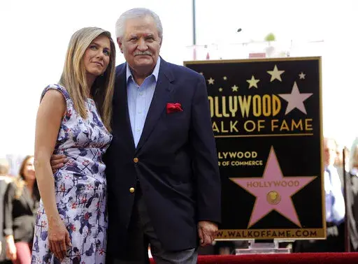 Actress Jennifer Aniston, left, poses with her father, actor John Aniston, after she received a star on the Hollywood Walk of Fame in Los Angeles on Feb. 23, 2012. John Aniston, the Emmy-winning star of the daytime soap opera “Days of Our Lives” and father of Jennifer Aniston, has died at age 89.  The actor’s daughter posted a tribute to him Monday morning on Instagram, announcing that he had died Friday, Nov. 11. (AP Photo/Chris Pizzello, File)