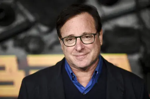 Bob Saget arrives at a screening of "MacGruber" on Dec. 8, 2021, in Los Angeles. Saget's family has released a statement on the cause of his death last month in Florida, citing authorities saying the actor-comedian died from an accidental blow to the head. (Photo by Richard Shotwell/Invision/AP, File)