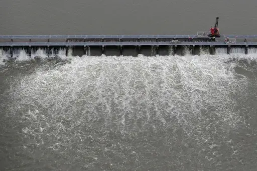 Workers open bays of the Bonnet Carre Spillway to divert rising water from the Mississippi River to Lake Pontchartrain, upriver from New Orleans, in Norco, La., May 10, 2019. The U.S. Army Corps of Engineers appealed a federal judge’s ruling Monday, March 20, 2023, that itmust consult with federal fisheries experts before opening the spillway that protects New Orleans from Mississippi River flooding. (AP Photo/Gerald Herbert, File)