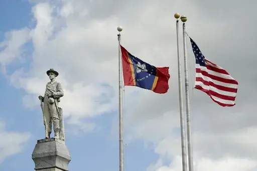 The Mississippi state and U.S. flags fly near the Rankin County Confederate Monument in the downtown square of Brandon, Miss., on March 3, 2023. Mississippi and Alabama closed most government offices Monday, April 24, for Confederate Memorial Day as efforts have stalled to abolish state holidays that honor the old Confederacy. (AP Photo/Rogelio V. Solis, File)