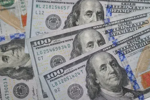 This Jan. 22, 2020, file photo shows the likeness of Benjamin Franklin on $100 bills in Dallas.  If you’re expecting a tax refund, you’re probably contemplating what to spend this newfound money on. There are several ways to use your windfall responsibly, but paying off debt could be the right option.  (AP Photo/LM Otero, File)