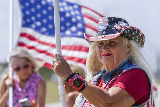Supporters wave flags as they wait for the motorcade of former President Donald Trump to arrive at Palm Beach International Airport in West Palm Beach, Fla., March 25, 2023. Millions of Americans will attend parades, fireworks, barbecues and other Independence Day events on Tuesday, celebrating the courage and sacrifices of the nation’s 18th century patriots who fought for the nation’s independence from England and what they considered an unjust government. (AP Photo/Gerald Herbert, File)