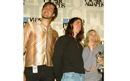 Nirvana band members, from left, Krist Novoselic, Dave Grohl and Kurt Cobain pose after receiving an award for best alternative video at the 10th annual MTV Video Music Awards in Universal City, Calif., on Sept. 2, 1993. A federal judge has dismissed the lawsuit of a 30-year-old man who alleged that the image of him nude as a baby on the 1991 cover of Nirvana’s “Nevermind" is child pornography. Judge Fernando Olguin granted the motion by Nirvana's attorneys to dismiss the case Monday, Jan. 3