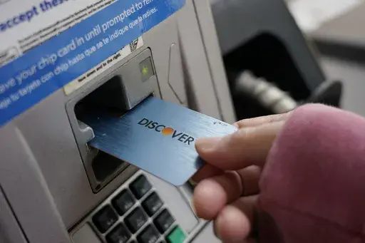 A Discover card is used to pay for gasoline at a Sam's Club in Madison, Miss., July 1, 2021. A combination of inflation, increased interest rates, and the end of pandemic-tied relief, such as the moratorium on student loan payments, has led to record credit card debt, experts say. (AP Photo/Rogelio V. Solis, File)