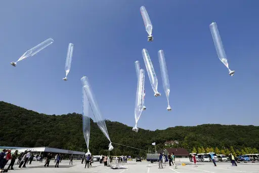 North Koran defectors release balloons carrying leaflets condemning North Korean leader Kim Jong Un and his government's policies, in Paju, near the border with North Korea, South Korea on  Oct. 10, 2014. North Korea suggested Friday, July 1, 2022 its COVID-19 outbreak began in people who had contact with balloons flown from South Korea, a highly questionable claim that appeared to be an attempt to hold its rival responsible amid increasing tensions. (AP Photo/Ahn Young-joon, File)