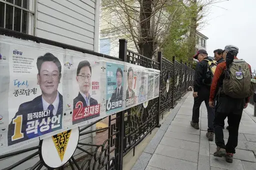 People pass by posters of candidates running for the upcoming parliamentary election in Seoul, South Korea, Wednesday, April 3, 2024. As South Koreans prepare to vote for a new 300-member parliament next week, many are choosing their livelihoods and other domestic topics as their most important election issues. This represents a stark contrast from past elections, which were overshadowed by security and foreign policy issues like North Korean nuclear threats and the U.S. security commitment.(AP 