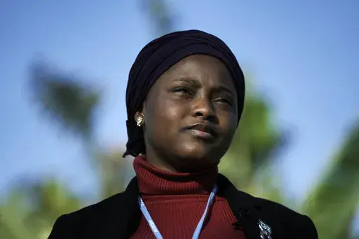 Nakeeyat Dramani Sam, of Ghana, poses for photos at the COP27 U.N. Climate Summit, Friday, Nov. 18, 2022, in Sharm el-Sheikh, Egypt. She made a plea for negotiators at the summit to come to an agreement that could help curb global warming. (AP Photo/Nariman El-Mofty)