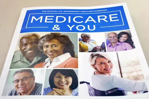 In this Nov. 8, 2018 file photo, the U.S. Medicare Handbook is photographed in Washington. Making more than the maximum income level for Medicaid isn’t necessarily a deal breaker. After a long pause during the COVID-19 public health emergency, states have resumed checking whether Medicaid beneficiaries’ income meets the eligibility requirements. (AP Photo/Pablo Martinez Monsivais)