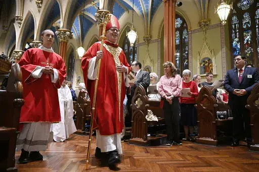 The Most Rev. Christopher J. Coyne, archbishop of Hartford, walks in a procession during a Pentecost Vigil at Blessed Michael McGivney Parish in St. Mary's Church, Saturday, May 18, 2024, in New Haven, Conn. The Eucharistic Procession from St. Mary's Church is one of four pilgrimage routes crossing the country and converging at the National Eucharistic Congress in Indianapolis on July 16. (AP Photo/Jessica Hill)