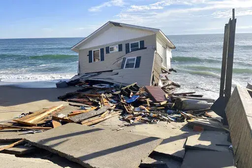 This image released by the National Park Service, shows a collapsed beachfront home along Ocean Drive in Rodanthe, N.C., on Wednesday, Feb. 9, 2022. The National Park Service issued a warning to visitors on Wednesday for debris. (National Park Service via AP, File)