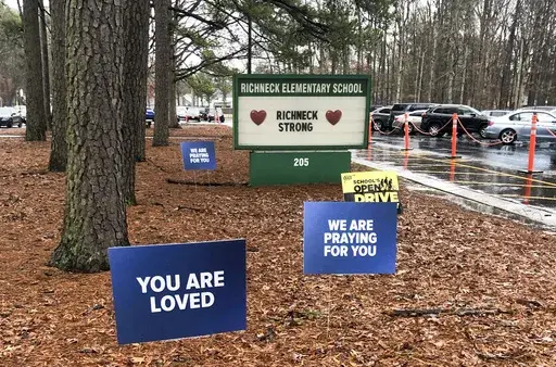 Signs stand outside Richneck Elementary School in Newport News, Va., Jan. 25, 2023. The first-grade teacher who was shot by her 6-year-old student at the Virginia school has resigned from her position, school officials said Tuesday, June 13, more than two months after she sued the district for $40 million. (AP Photo/Denise Lavoie, File)
