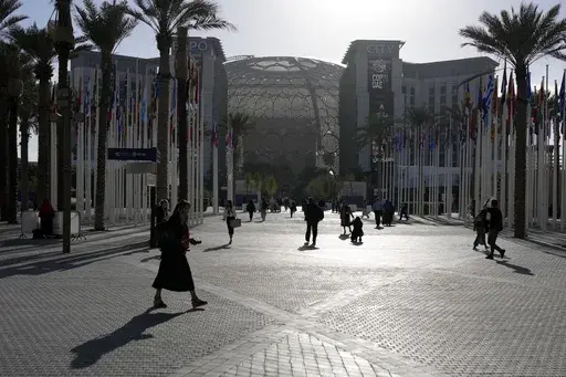 People walk through the venue at the COP28 U.N. Climate Summit near the Al Wasl Dome at Expo City, Thursday, Nov. 30, 2023, in Dubai, United Arab Emirates. (AP Photo/Rafiq Maqbool, File)