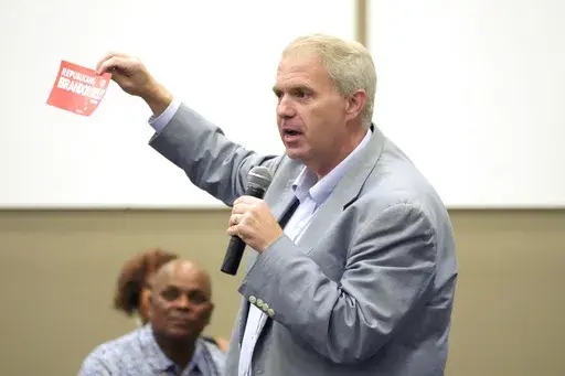 Northern District Public Service Commissioner Brandon Presley, the Democratic candidate for governor in November, shows off a bumper sticker that indicates the Republican driver is a Presley supporter during a campaign stop in Summit, Miss., Thursday, Sept. 14, 2023. (AP Photo/Rogelio V. Solis)