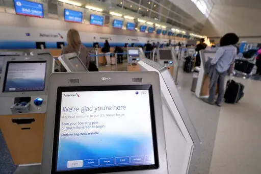 Travelers use kiosk to check their bags as they arrive to travel out of Dallas/Fort Worth International airport Tuesday, Nov. 22, 2022, in Grapevine, Texas.  Pandemic rebooking issues drove many air passengers to book directly with airlines instead of third-party travel sites. While ancillary fees have become a major part of airline revenue over the past 15 years, airlines have more recently ramped up efforts to drive revenue from add-on fees. (AP Photo/Tony Gutierrez)