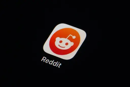 The Reddit app icon is seen on a smartphone on Feb. 28, 2023, in Marple Township, Pa. More than 8,000 subreddits, or Reddit communities, have gone dark as of Tuesday, June 13, in protest of upcoming API changes, which include a controversial policy that will charge some third-party apps for continued use. (AP Photo/Matt Slocum, File)