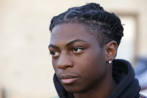 Darryl George, a 17-year-old junior, before walking across the street to go into Barbers Hill High School after serving a 5-day in-school suspension for not cutting his hair Monday, Sept. 18, 2023, in Mont Belvieu. George will spend the remainder of the year in in-school suspension, extending a punishment that was first imposed in August over his hairstyle that district officials maintain violates their dress code policy. A referral given to George Tuesday, Dec. 5, said his hair is “out of com