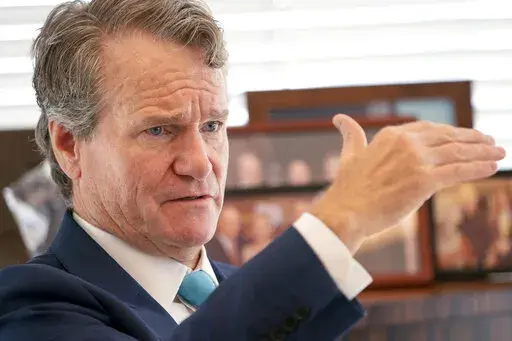 Brian Moynihan, CEO of Bank of America, is photographed during an interview at the Bank of America Tower, Wednesday, Aug. 17, 2022, in the Manhattan borough of New York.  Bank of America says the revenue it gets from overdrafts has dropped 90% from a year ago, after the bank reduced overdraft fees to $10 from $35 and eliminated fees for bounced checks.   (AP Photo/John Minchillo)