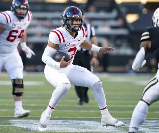 Mississippi quarterback Jaxson Dart (2) scrambles past the Vanderbilt defense during the third quarter of an NCAA college football game Saturday, Oct. 8, 2022, in Nashville, Tenn. (George Walker IV/The Tennessean via AP)