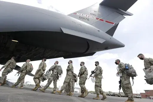 Tennessee National Guard troops board a plane in Smyrna, Tenn., to go to Washington, Thursday, June 4, 2020.  Three current and former members of the Tennessee National Guard are “safe” and “accounted for,” despite a Russian newspaper’s false report, Thursday, March, 17, 2022, that the men were killed while fighting in Ukraine.  All three individuals named in the report, are alive and well — and no U.S. military personnel are currently on orders in Ukraine, National Guard Bureau spok