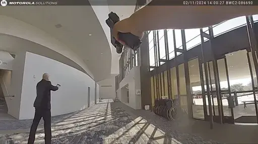 In this image taken from body camera video released by the Houston Police Department on Monday, Feb. 26, 2024, officers and security respond after exchanging gunfire with a woman who opened fire at celebrity pastor Joel Osteen’s Houston megachurch Sunday, Feb. 11. Police say Genesse Moreno, 36, entered the church between Sunday services with her 7-year-old son and began firing an AR-style rifle. (Houston Police Department via AP)