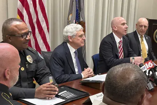 U.S. Attorney General Merrick Garland, center, meets with U.S Attorney for the Southern District of Mississippi Todd Gee, second from right, and local law enforcement representatives, Wednesday, Sept. 25, 2024, in Jackson, Miss. (Jerry Mitchell/Mississippi Today via AP)