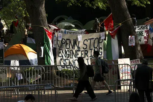 People walk past the Gaza Solidarity Encampment at the University of Pennsylvania in Philadelphia, Tuesday, April 30, 2024. In the wake of pro-Palestinian protesters on college campuses calling for universities to divest from Israel, Pennsylvania’s state Senate on Thursday, June 27, 2024, approved legislation that would block state aid from going to any university that boycotts or divests from Israel. (Monica Herndon/The Philadelphia Inquirer via AP, File)