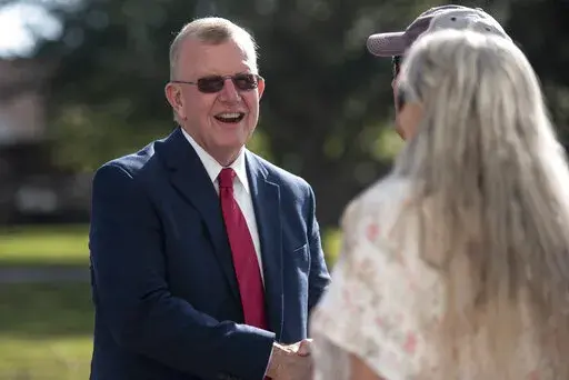 Jackson County Sheriff Mike Ezell, the Republican candidate for Mississippi's 4th Congressional District, shakes hands with voters after he voted at First Presbyterian Church in Pascagoula, Miss., Tuesday, Nov. 8, 2022. (Hannah Ruhoff/The Sun Herald via AP)