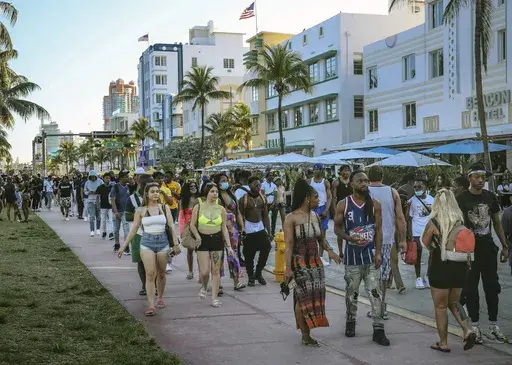 Tourists walk alongside Ocean Drive in Miami Beach, Fla., on March 21, 2021. A water main break in Miami Beach caused pressure to drop and forced officials to issue a boil water alert for the tourism hotspot on Friday, July 21, 2023. (Carl Juste/Miami Herald via AP, File)
