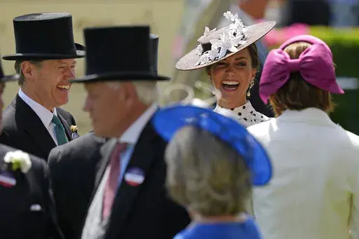 Kate, Duchess of Cambridge, second right, laughs as she stands in the paddock on the fourth day of the Royal Ascot horserace meeting, at Ascot Racecourse, in Ascot, England, Friday, June 17, 2022. Every June, Britain's royals, aristocrats and thousands of stylish guests don their finest headgear for Royal Ascot, a glamorous annual horse racing event that dates back to 1711, when Queen Anne founded Ascot Racecourse in Berkshire, southern England. (AP Photo/Alastair Grant)