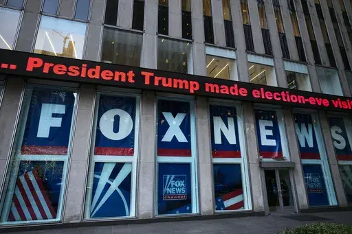 A headline about President Donald Trump is displayed outside Fox News studios in New York on Nov. 28, 2018. Documents in defamation lawsuit illustrate pressures faced by Fox News journalists in the weeks after the 2020 presidential election. The network was on a collision course between giving its conservative audience what it wanted and reporting uncomfortable truths about then-President Donald Trump and his false fraud claims. (AP Photo/Mark Lennihan, File)