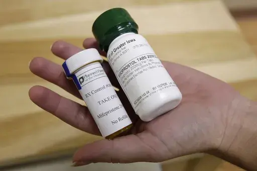 Bottles of abortion pills mifepristone, left, and misoprostol, right, at a clinic in Des Moines, Iowa, Sept. 22, 2010. A federal appeals court has preserved access to an abortion drug for now but under tighter rules that would allow the drug only to be dispensed up to seven weeks, not 10, and not by mail. (AP Photo/Charlie Neibergall, File)