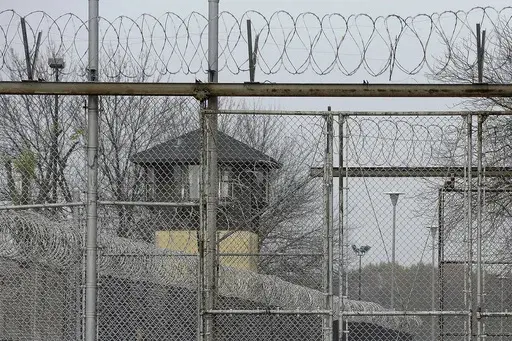 Security fences surround the Illinois Department of Corrections' Logan Correctional Center, Nov. 18, 2016, in Lincoln, Ill. Illinois Gov. J.B. Pritzker's administration has retained a contentious choice for providing medical care to prison inmates, awarding Wexford Health Sources a 10-year, $4.16 billion contract despite high vacancy rates, complaints of substandard care and lawmakers' agitation to find a replacement. (AP Photo/Seth Perlman, File)