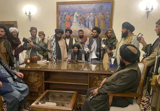 Taliban fighters take control of the Afghan presidential palace after Afghan President Ashraf Ghani fled the country, in Kabul, Afghanistan, on Aug. 15, 2021. (AP Photo/Zabi Karimi, File)