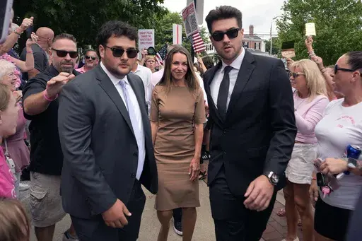 Karen Read, center, is flanked by security as she arrives at Norfolk Superior Court for a hearing, Monday, July 22, 2024, in Dedham, Mass. (AP Photo/Charles Krupa)