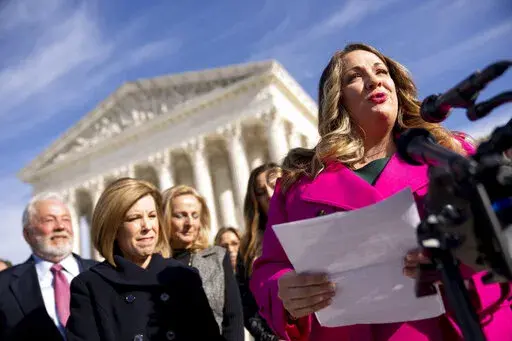 Lorie Smith, a Christian graphic artist and website designer in Colorado, right, accompanied by her lawyer, Kristen Waggoner of the Alliance Defending Freedom, second from left, speaks outside the Supreme Court in Washington, Monday, Dec. 5, 2022, after her case was heard before the Supreme Court. The Supreme Court is hearing the case of Smith, who objects to designing wedding websites for gay couples, that's the latest clash of religion and gay rights to land at the highest court. (AP Photo/And