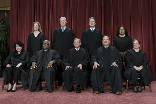 Members of the Supreme Court sit for a new group portrait following the addition of Associate Justice Ketanji Brown Jackson, at the Supreme Court building in Washington, on Oct. 7, 2022. Bottom row, from left, Associate Justice Sonia Sotomayor, Associate Justice Clarence Thomas, Chief Justice of the United States John Roberts, Associate Justice Samuel Alito, and Associate Justice Elena Kagan. Top row, from left, Associate Justice Amy Coney Barrett, Associate Justice Neil Gorsuch, Associate Justi