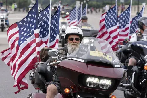 Participants in the "Rolling to Remember" motorcycle rally ride past Arlington Memorial Bridge during the annual motorcycle parade, ahead of Memorial Day, in Washington, Sunday, May 28, 2023. (AP Photo/Jose Luis Magana, File)