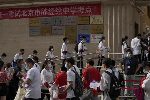 Students line up to enter a school for the first day of China's national college entrance examinations, known as the gaokao, in Beijing, Tuesday, June 7, 2022. After the pandemic, young Chinese are again looking to study abroad. But the decades-long run that has sent an estimated 3 million Chinese students to the U.S. could be trending down. (AP Photo/Andy Wong, File )