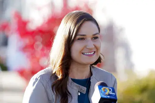 In this Nov. 3, 2020 file photo, Abby Finkenauer talks with journalists at the Linn County Democrats' office in Cedar Rapids, Iowa. A state court judge has concluded that Democrat Abby Finkenauer cannot appear on the June 7 primary ballot for U.S. Senate, knocking off the candidate considered by many to be the party's leader in the effort to challenge U.S. Sen. Charles Grassley. (Liz Martin/The Gazette via AP, File)