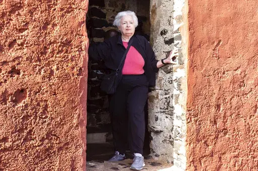 U.S. Treasury Secretary Janet Yellen stands in the "Door Of No Return" on Goree Island, Senegal, Saturday Jan. 21, 2023. Yellen has paid a solemn visit to an island off Senegal that is one of the most recognized symbols of the horrors of the Atlantic slave trade that trapped tens of millions of Africans in bondage. She is in Senegal as part of a 10-day trip aimed at rebuilding economic relationships between the U.S. and Africa. (AP Photo/Stefan Kleinowitz)