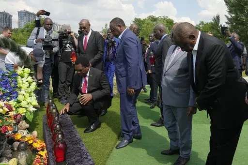 From right, South African President Cyril Ramaphosa, President of the Union of Comoros Azali Assoumani, Senegal's President Macky Sall, and Zambia's President Hakainde Hichilema, bottom, attend a commemoration ceremony at a site of a mass grave in Bucha, on the outskirts of Kyiv, Ukraine, Friday, June 16, 2023. South African President Cyril Ramaphosa arrived in Ukraine on Friday as part of a delegation of African leaders and senior officials seeking ways to end Kyiv's 15-month war with Russia. (