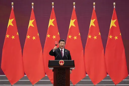 Chinese President Xi Jinping raises his glass and proposes a toast during the welcome banquet for visiting leaders attending the Belt and Road Forum at the Great Hall of the People, on April 26, 2019. China's Belt and Road Initiative looks to become smaller and greener after a decade of big projects that boosted trade but left big debts and raised environmental concerns. (Nicolas Asfouri/Pool Photo via AP, File)